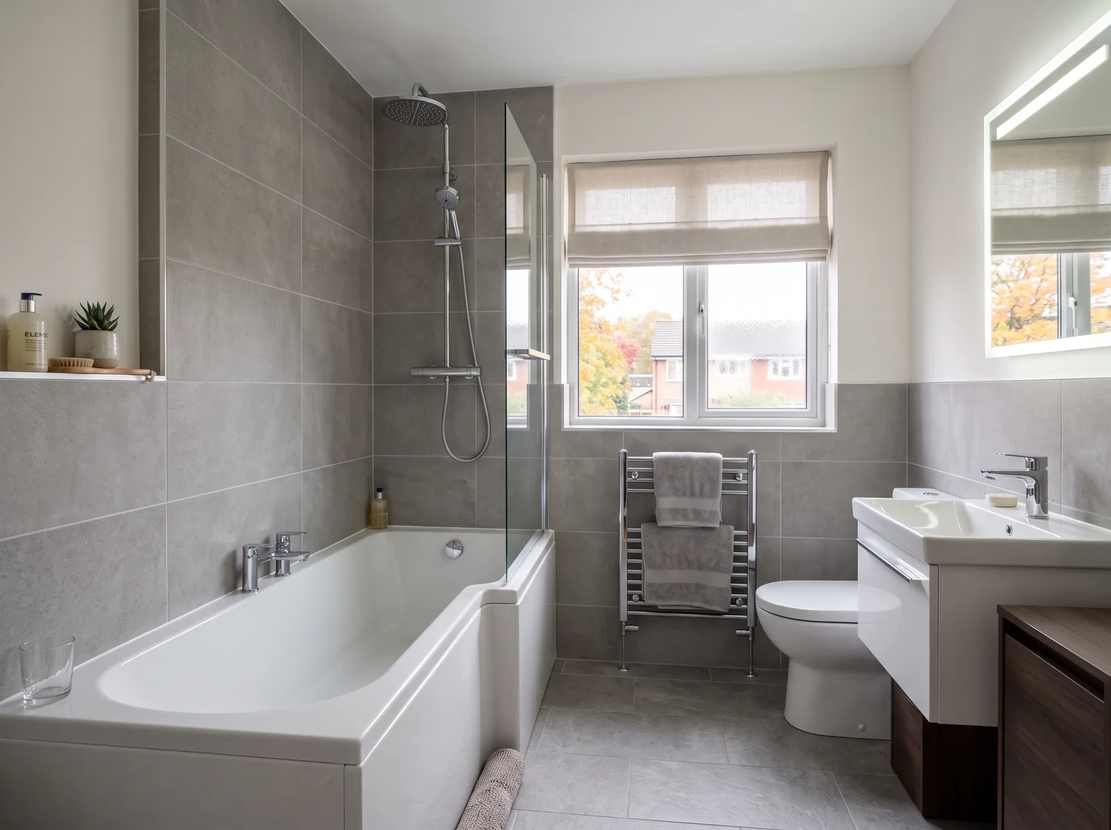 Finished family bathroom with white suite and grey tiles